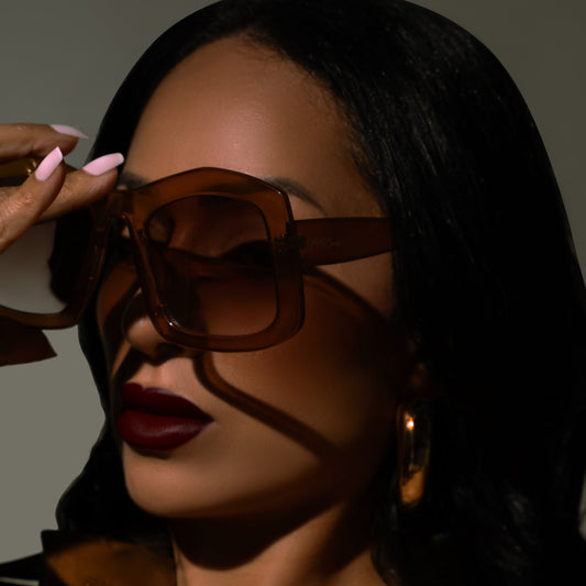 Woman wearing sunglasses with a neutral background