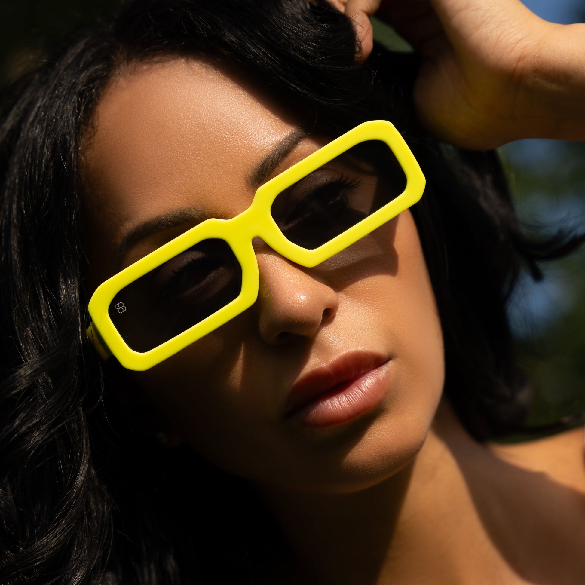 Woman wearing bright yellow sunglasses from the brand 1980nine